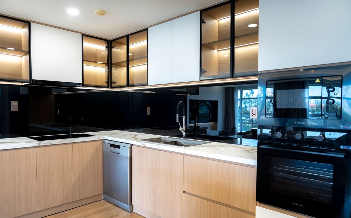 Fluted and tinted glass cabinet doors give a dark kitchen depth without visual clutter.
