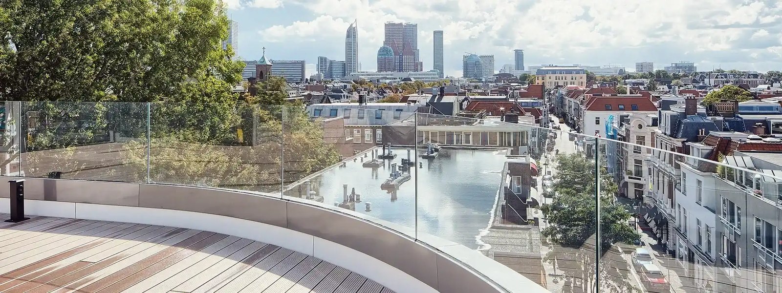 A rooftop terrace railing in glass and stainless steel: wind load, height and fixing type decide the spec.