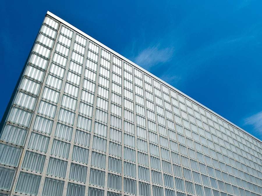 A channel-glass facade at building scale: self-supporting U-profiles, translucent rather than transparent.